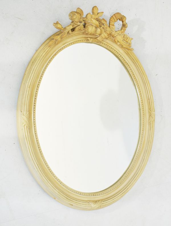 Oval framed mirror having ribbon and rose cresting Condition: