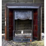 Cast iron fire inset having dark red glazed tiles Condition: