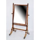 Early 19th Century mahogany cheval mirror supported on turned columns and twin splayed supports,