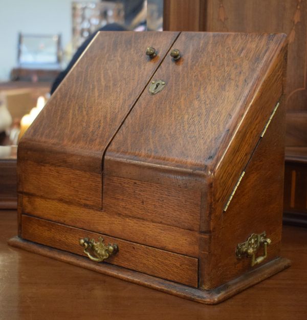 Early 20th Century oak slope front stationery cabinet having pigeon holed interior and glass inkwell