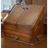 Early 20th Century oak slope front stationery cabinet having pigeon holed interior and glass inkwell