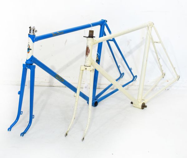 Vintage racing cycle frames comprising: Sun frame in blue, with white head tube and gold decals,