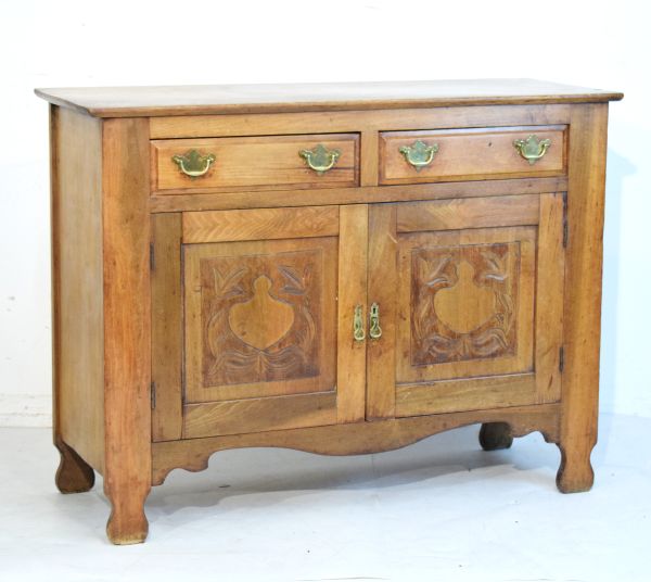 Late 19th/early 20th Century beech sideboard fitted two short drawers above a pair of carved panel