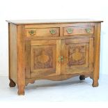 Late 19th/early 20th Century beech sideboard fitted two short drawers above a pair of carved panel