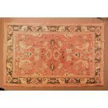 20th Century carpet having flower and foliage decoration against a salmon pink ground with multi