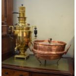 Russian brass samovar, 61cm tall, together with a circular copper vessel and cover on three scroll