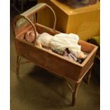 1930's period wicker dolls crib together with an Armand Marseille bisque head doll having a