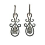 Pair of diamond set 18ct white gold drop earrings, the central pear shaped drop composed of two