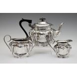 Edward VII silver three piece tea set having lobed and embossed decoration, maker Joseph Gloster,