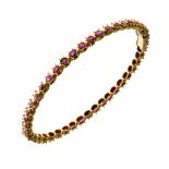 Hinged ruby set bangle, probably of Indian origin, 6.1cm internal diameter, 14.5g gross Condition: