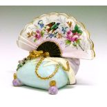 Meissen style menu holder decorated with a fan, lady's gloves, beads etc, base with crossed swords