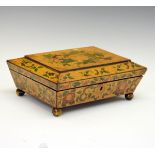 Regency pine sarcophagus shaped work box having painted foliate decoration and standing on brass