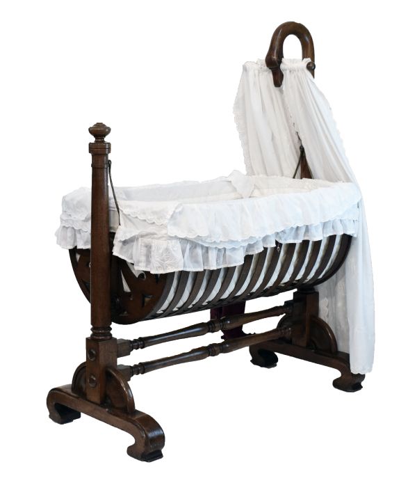 Victorian mahogany rocking crib, the raised head support formed as the bowed head of a swan,