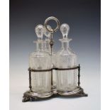 Set of three cut glass decanters and stoppers, on a silver plated trefoil shaped stand having a
