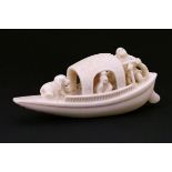 Japanese carved ivory okimono, Meiji period, formed as three figures and a dog on a boat, 9.75cm