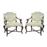 Pair of late 19th Century Continental carved beech and walnut open arm elbow chairs, possibly