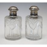 Pair of early 20th Century Fabergé cut glass scent bottles, having pull-off silver tops with