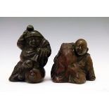 Two Japanese bronze coloured metal okimono, the first formed as a seated man with a dog, 5cm high,