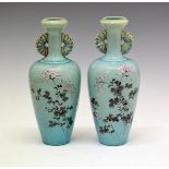 Pair of Japanese earthenware baluster vases, each having polychrome foliate decoration on a pale