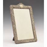 Edward VII embossed silver framed rectangular bevelled easel mirror having stylised foliate