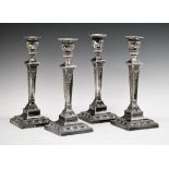 Set of four 19th Century Adam style silver plated candlesticks, each having ribbon and swag