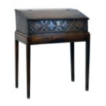 Antique oak slope front Bible box and stand having a foliate and lozenge carved frieze and