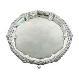 George II silver salver having a gadrooned pie-crest edge and standing on triple pad feet, maker