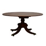Regency satinwood crossbanded mahogany oval snap-top breakfast table standing on a turned pillar and