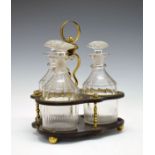 Regency brass mounted black lacquered trefoil shaped decanter stand having a central loop handle and