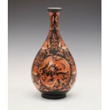 Porcelain bottle shaped vase having red painted decoration depicting dragons amongst scrolling