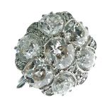 Seven stone diamond cluster ring, stamped 'Plat', the centre stone of approximately 0.9 carats, with