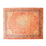 Modern Middle Eastern wool carpet decorated with a central medallion amongst scrolling foliage on