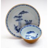 Nanking Cargo tea bowl and saucer having blue and white painted foliate decoration and exterior café