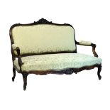 Edwardian carved walnut framed two seater drawing room settee upholstered in pale green and off-