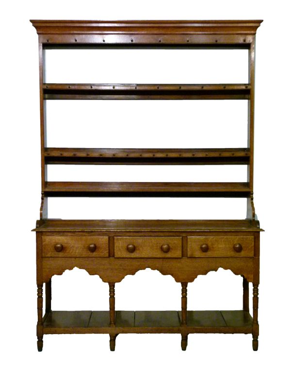 19th Century oak high dresser, the open backed plate rack having moulded cornice, fitted four