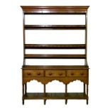 19th Century oak high dresser, the open backed plate rack having moulded cornice, fitted four