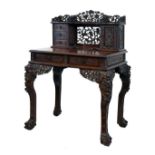 Late 19th/early 20th Century Chinese heavy hardwood writing table, the raised back having a prunus