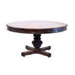 19th Century Anglo-Indian carved mahogany circular snap top breakfast table having a decorative