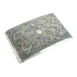 Chinese white metal cigarette case decorated with dragons in relief on an orange peel ground,