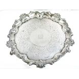 William IV engraved silver salver having a central engraved crest and standing on triple scroll