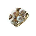 Cultured pearl and diamond dress ring, stamped '14k', the four pearls of approximately 6.5mm