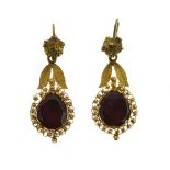 Pair of Victorian garnet drop earrings, the flat cut stones with a leaf motif above, 3.2cm long,