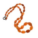 Graduated row of oval amber beads, the twenty-six beads to a bolt ring clasp, 50cm long, 34.9g gross