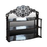 Victorian rosewood and mahogany three tier wall shelf having a raised mirror back fretwork pediment,