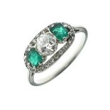 Diamond and emerald three stone ring, the central old brilliant cut of approximately 0.5 carats,