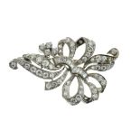 Diamond ribbon bow brooch in unmarked white metal, set throughout with brilliant, single and
