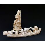 Japanese carved ivory figure group depicting three figures in a boat, 19.5cm long together with
