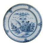 18th Century Liverpool Delft charger having blue and white painted decoration depicting a fenced