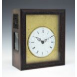 Chinese hardwood cased table clock, the case with glazed and fret carved side panels, sliding
