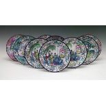Nine Chinese enamel plates decorated with figures in a garden, on a terrace and on horseback, each